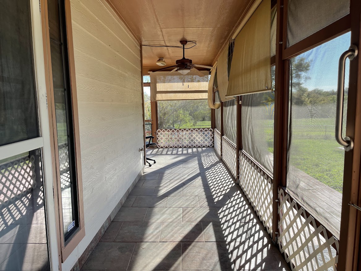 5001 Blue Bluff Road Austin, TX 78724 - Photo 3 of 7 Unfurnished sunroom featuring ceiling fan