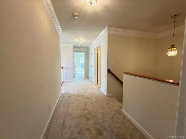 a view of a hallway to rooms