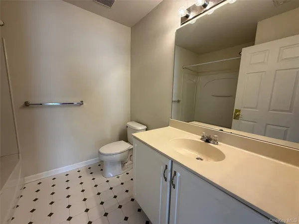 a bathroom with a sink toilet and vanity