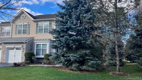 a view of house with a yard and potted plants