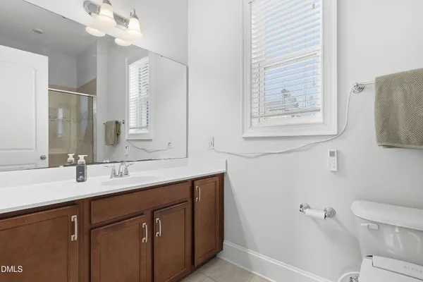 a bathroom with a sink vanity and a mirror