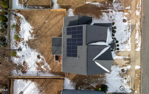 an aerial view of a house with swimming pool patio and outdoor seating