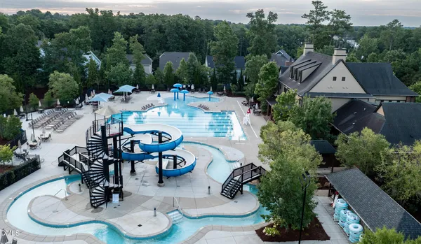 an aerial view of a house with garden space and street view