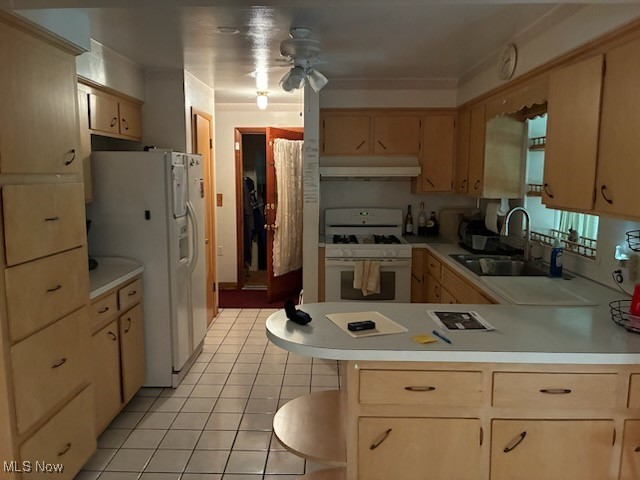 5514 Detroit Road Elyria, OH 44035 - Photo 6 of 8 Kitchen featuring white appliances, light countertops, light tile patterned floors, ceiling fan, and a peninsula