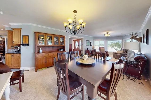 a living room with furniture a flat screen tv and wooden floor