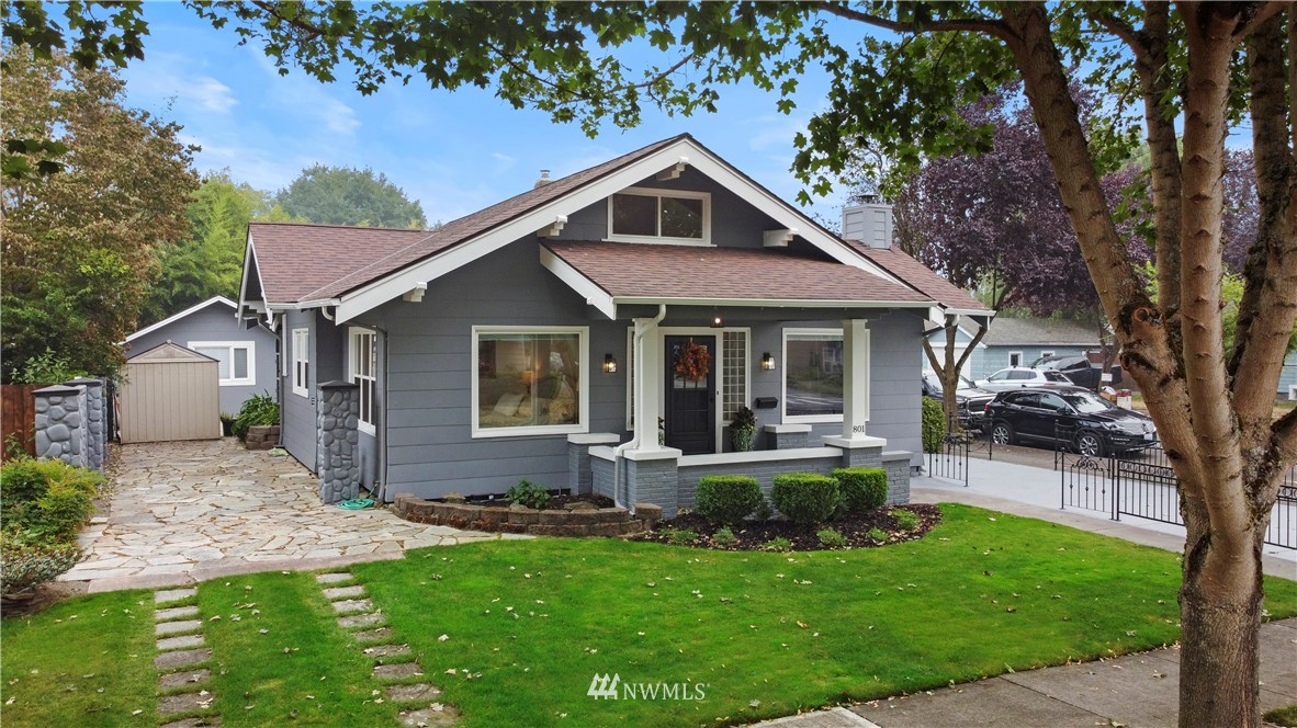 801 Ryan Avenue Sumner, WA 98390 - Photo 3 of 35 a front view of house with a garden and patio