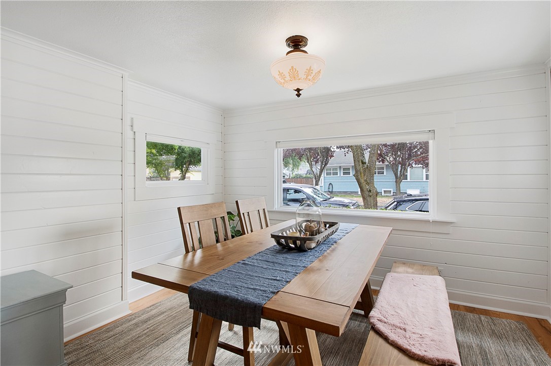 801 Ryan Avenue Sumner, WA 98390 - Photo 22 of 35 a view of a dining room with furniture a chandelier and wooden floor