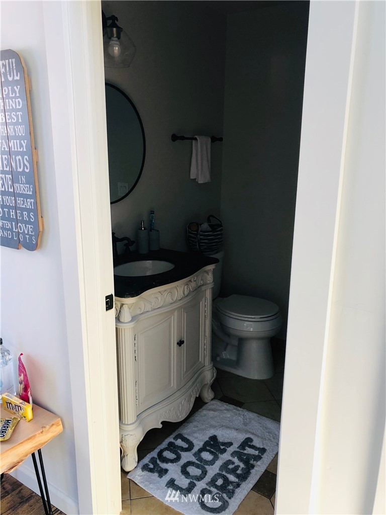 801 Ryan Avenue Sumner, WA 98390 - Photo 35 of 35 a bathroom with a granite countertop toilet and a sink