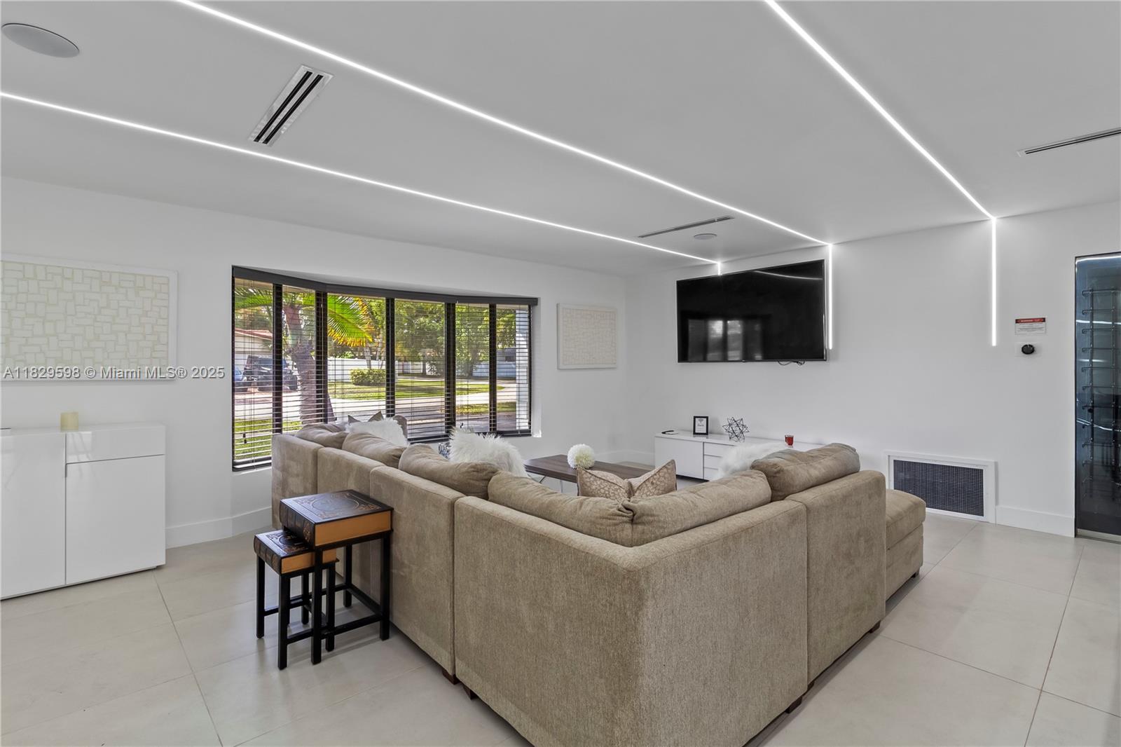 5131 Monroe Street Hollywood, FL 33021 - Photo 16 of 52 a living room with furniture and a flat screen tv