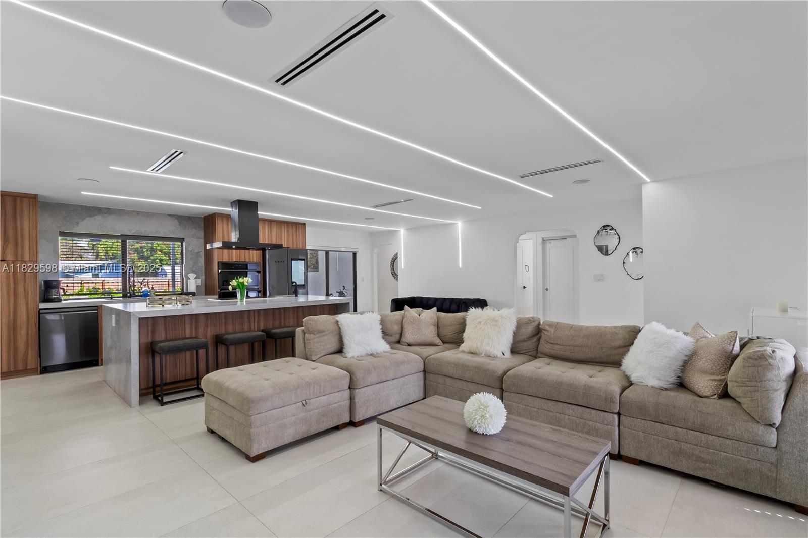 5131 Monroe Street Hollywood, FL 33021 - Photo 17 of 52 a living room with furniture and a table