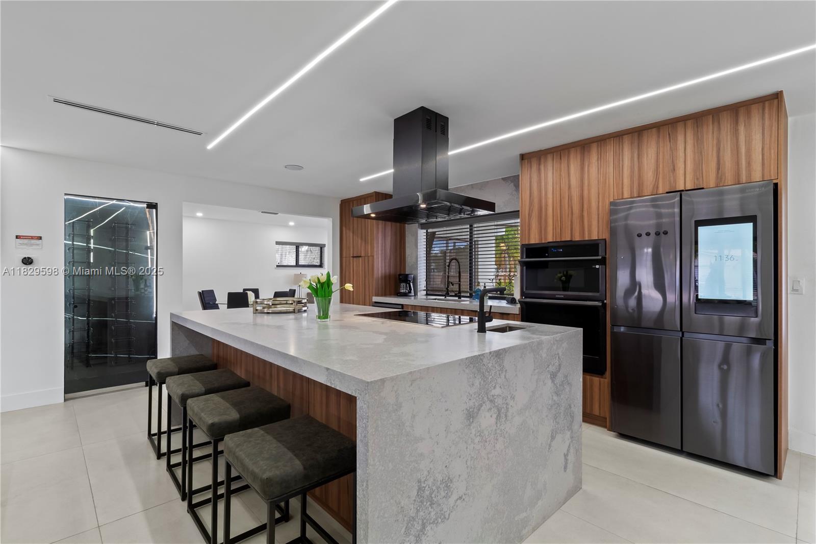 5131 Monroe Street Hollywood, FL 33021 - Photo 18 of 52 a kitchen with kitchen island a counter top space appliances and cabinets