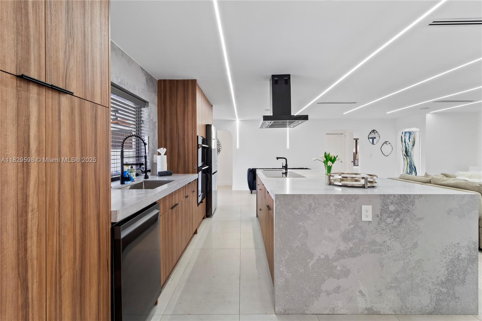 5131 Monroe Street Hollywood, FL 33021 - Photo 20 of 52 a large kitchen with kitchen island granite countertop a sink a counter top space and stainless steel appliances