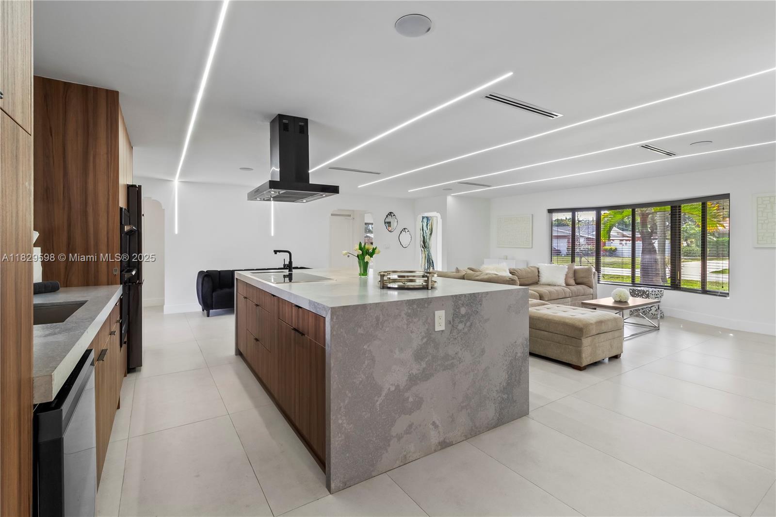 5131 Monroe Street Hollywood, FL 33021 - Photo 21 of 52 a living room with furniture and a flat screen tv