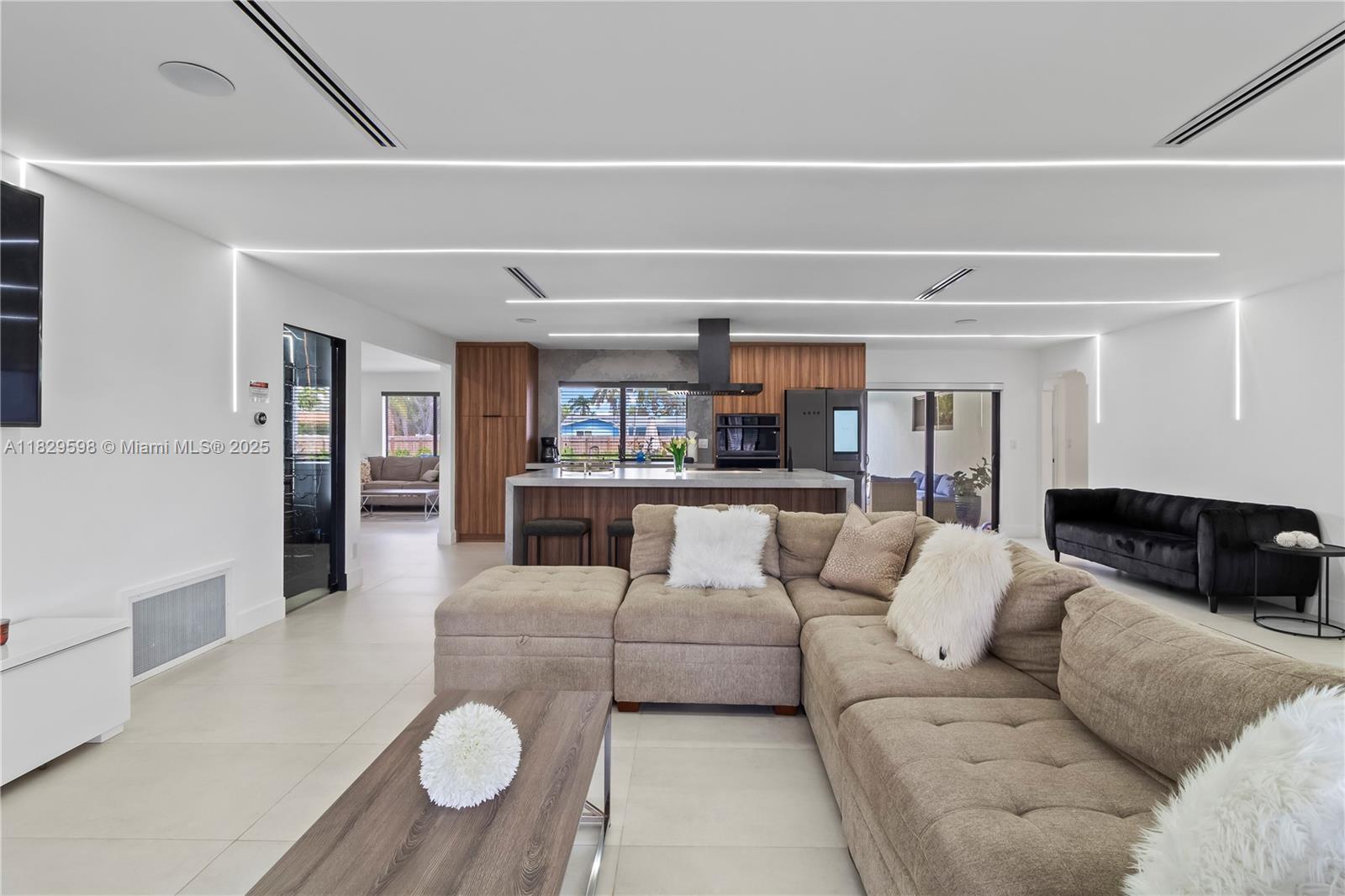 5131 Monroe Street Hollywood, FL 33021 - Photo 25 of 52 a living room with furniture and a view of kitchen