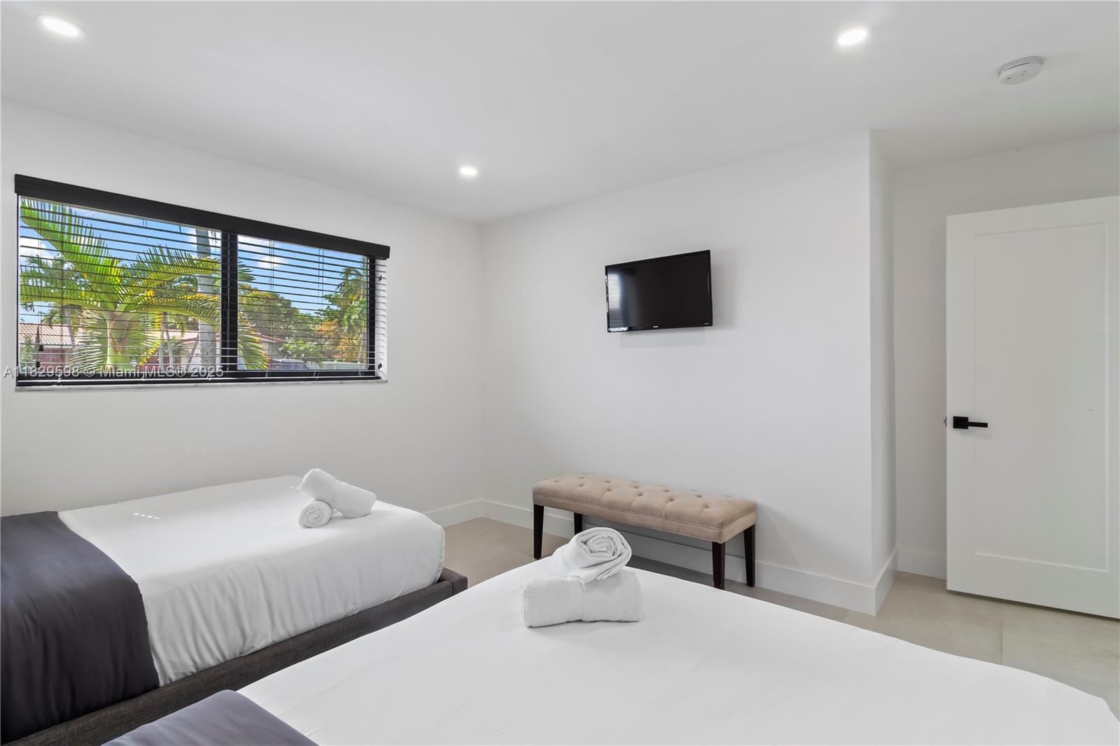 5131 Monroe Street Hollywood, FL 33021 - Photo 28 of 52 a bedroom with a bed and a flat screen tv