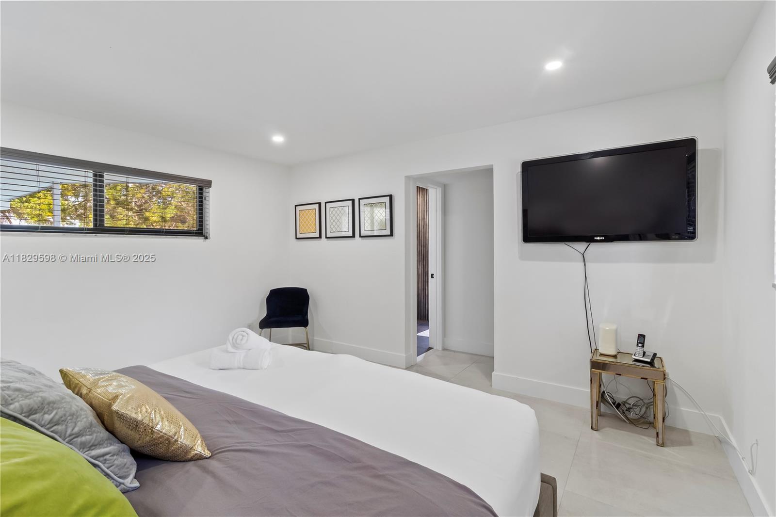 5131 Monroe Street Hollywood, FL 33021 - Photo 33 of 52 a bedroom with a bed and a flat screen tv