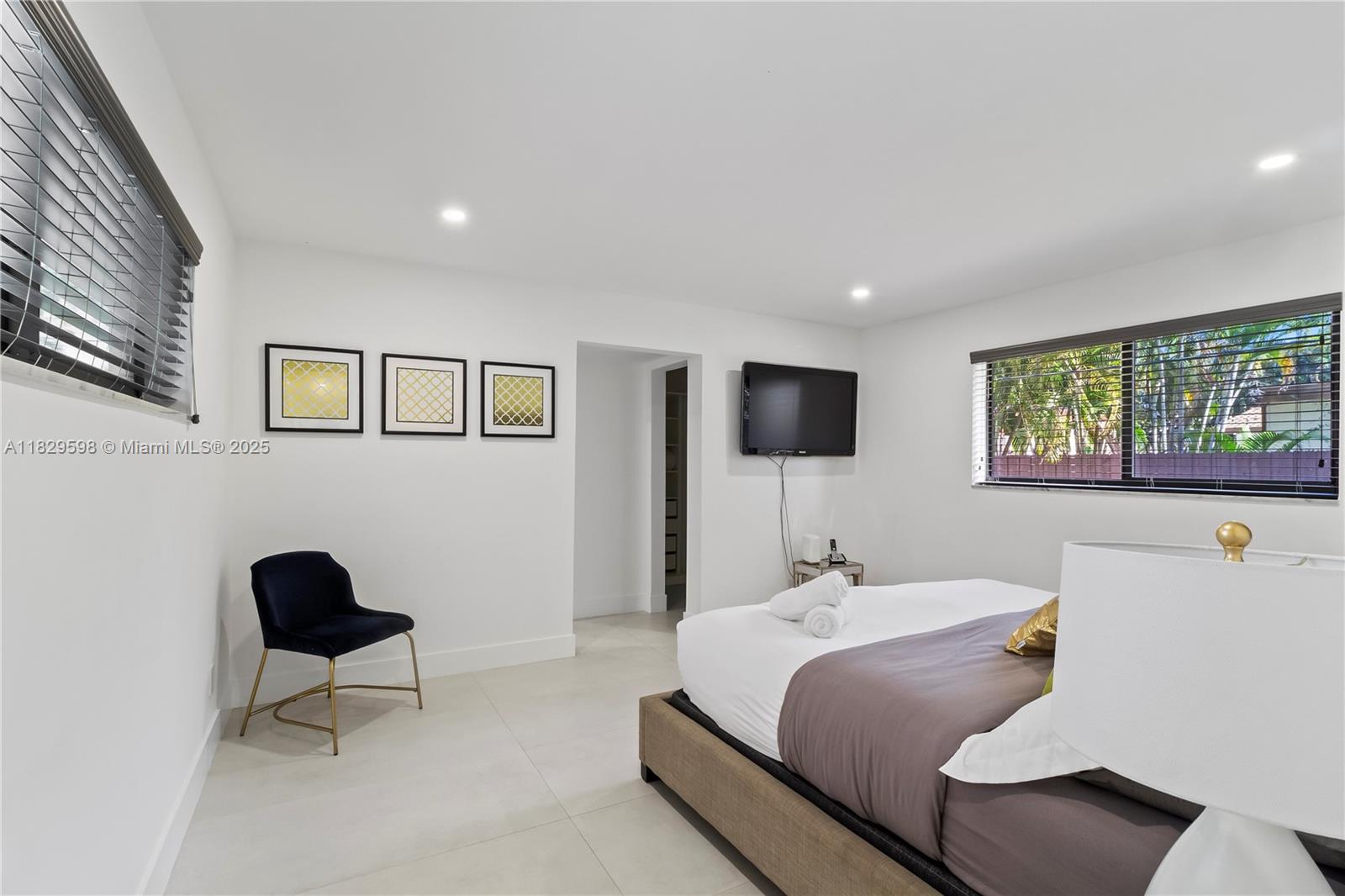 5131 Monroe Street Hollywood, FL 33021 - Photo 35 of 52 a bedroom with a bed and a flat screen tv