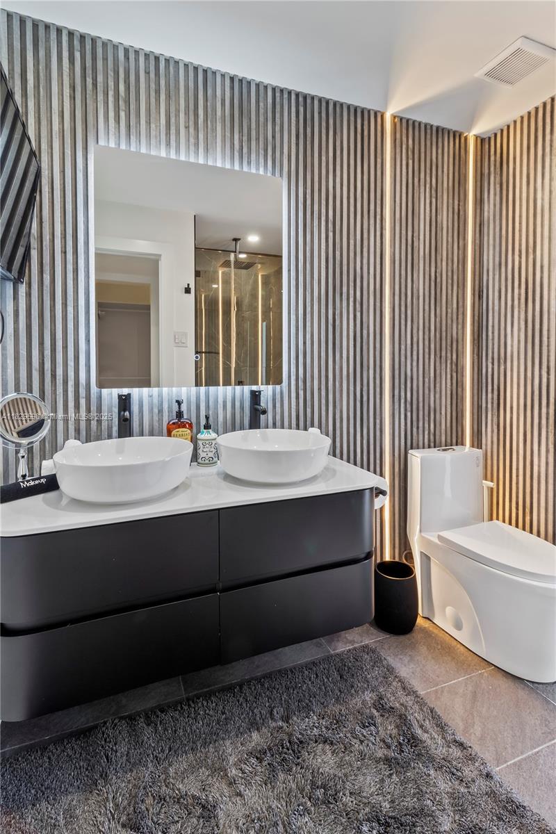 5131 Monroe Street Hollywood, FL 33021 - Photo 40 of 52 a bathroom with a sink and a mirror