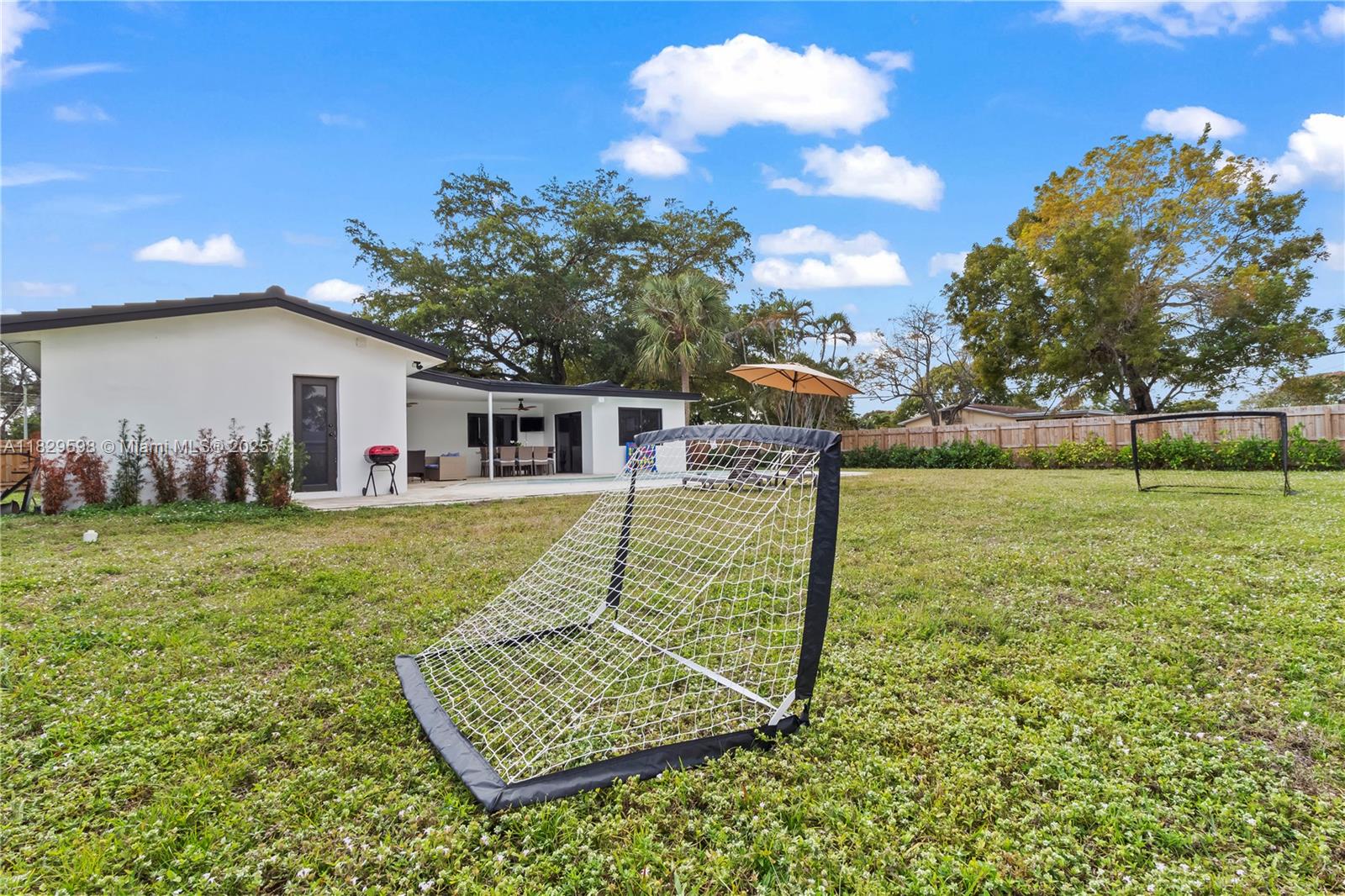 5131 Monroe Street Hollywood, FL 33021 - Photo 51 of 52 a view of a house with backyard and a tree