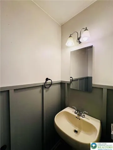 a bathroom with a sink and mirror