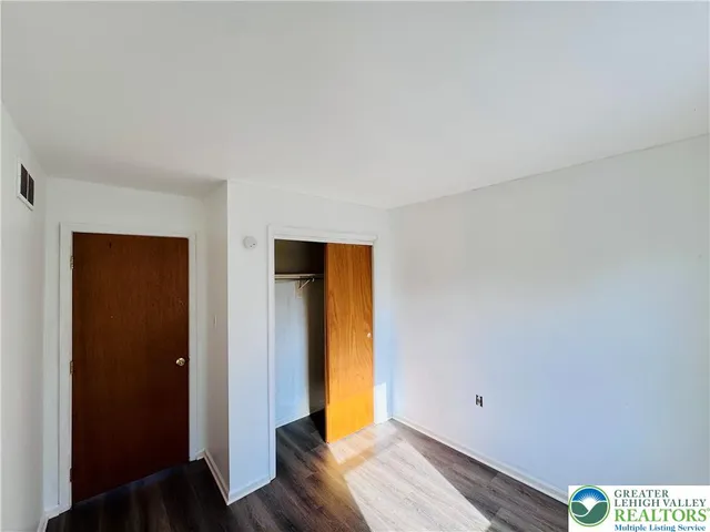a view of room with wooden floor and bedroom