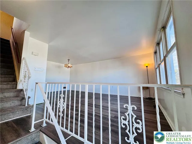a view of staircase with wooden floor and stairs