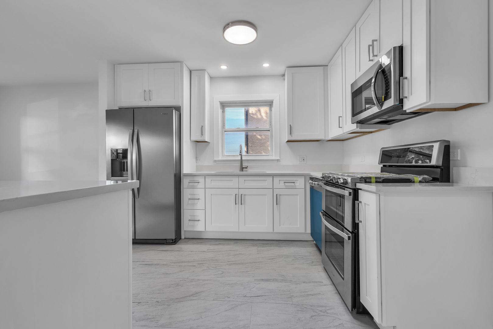 512 Ida Court, Unit 2 Mount Prospect, IL 60056 - Photo 7 of 16 a kitchen with stainless steel appliances granite countertop a refrigerator and a stove top oven
