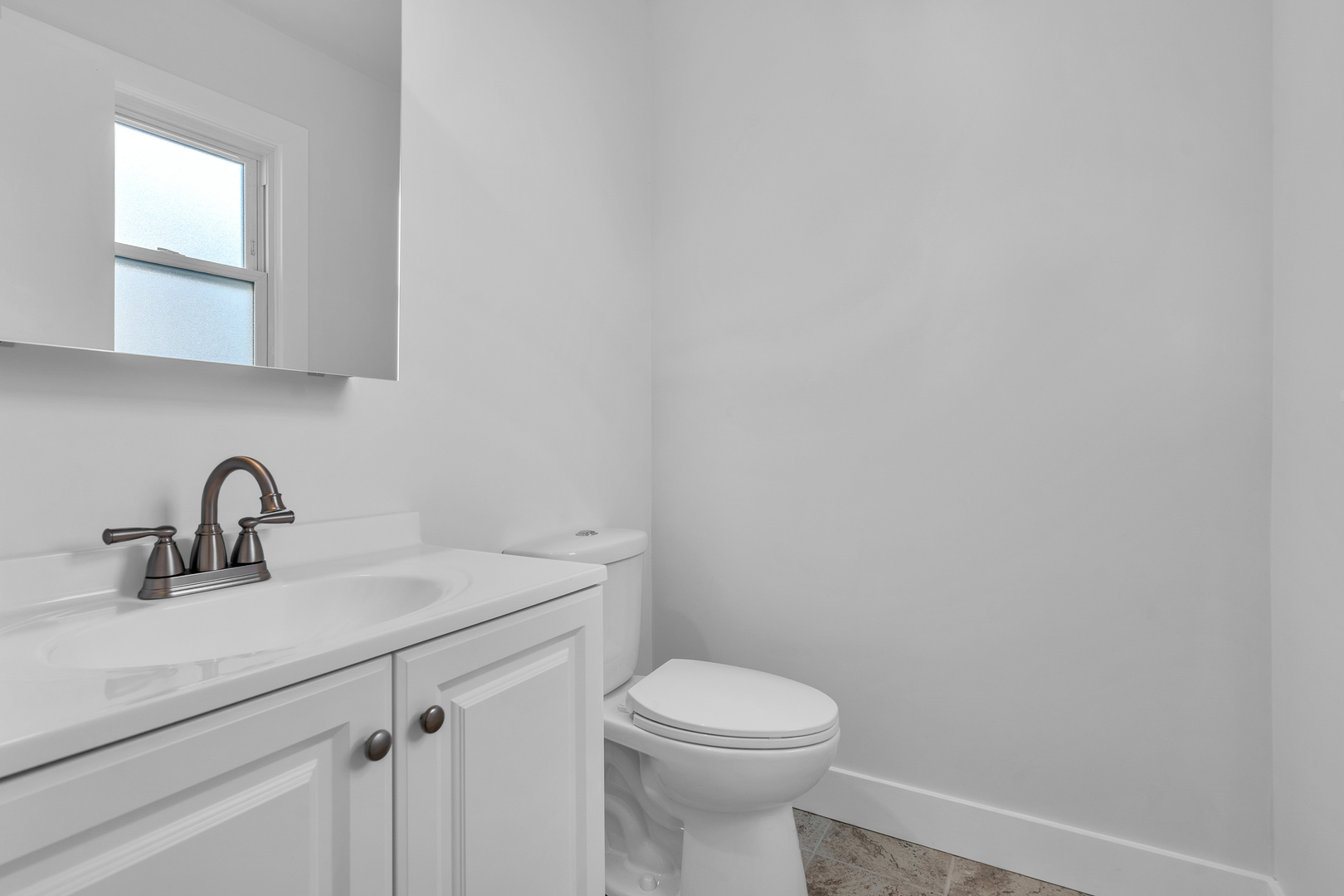 512 Ida Court, Unit 2 Mount Prospect, IL 60056 - Photo 8 of 16 a bathroom with a sink a toilet and mirror