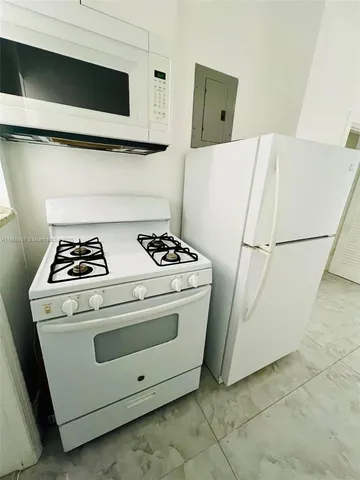 a kitchen with refrigerator and window