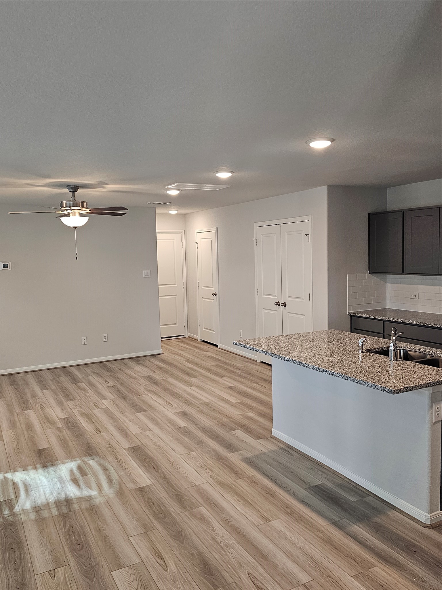 5207 Shallowhurst Lane Katy, TX 77449 - Photo 13 of 27 a large white kitchen with a sink and a large mirror