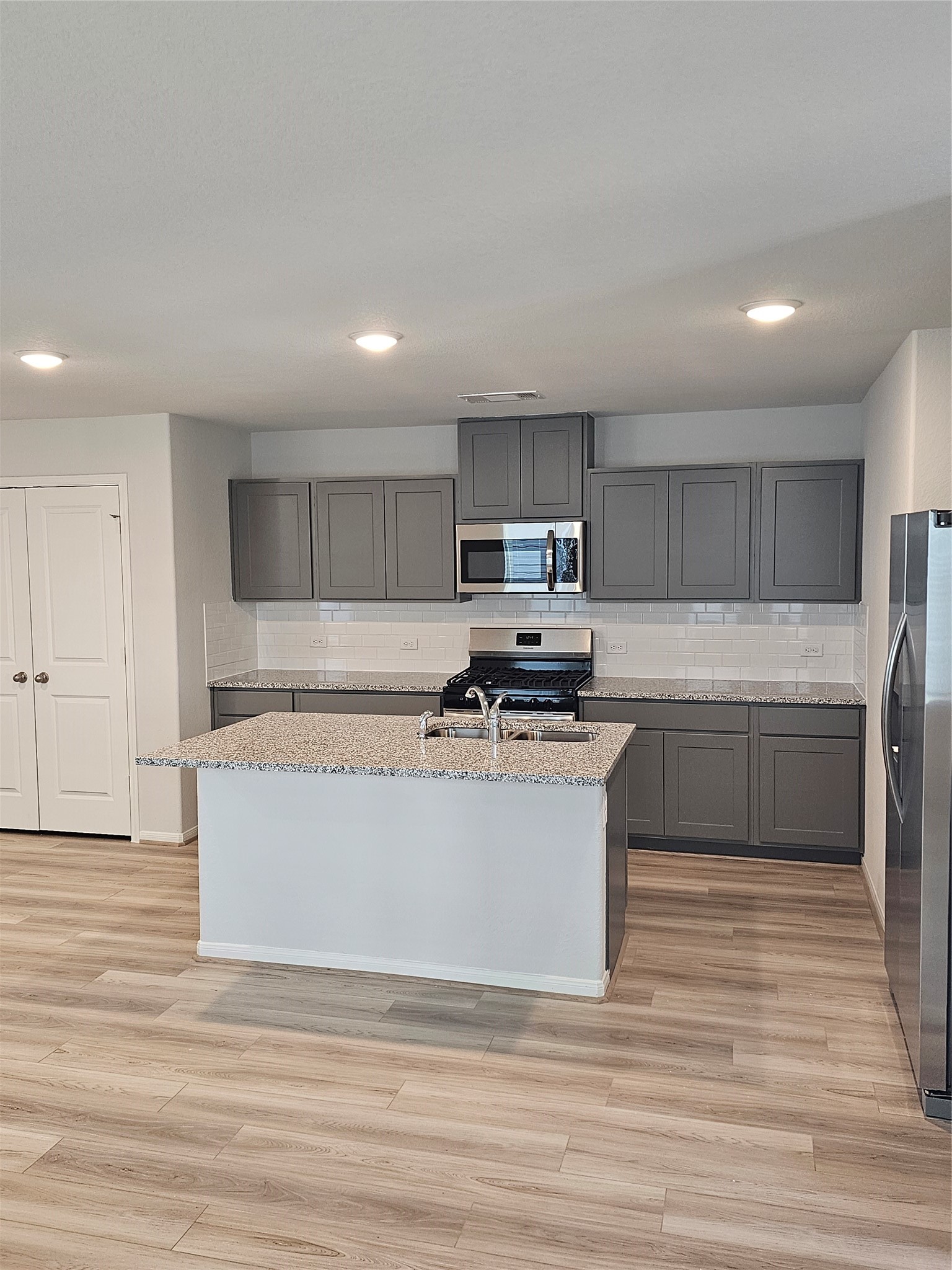 5207 Shallowhurst Lane Katy, TX 77449 - Photo 14 of 27 a kitchen with stainless steel appliances granite countertop a stove a sink and a refrigerator