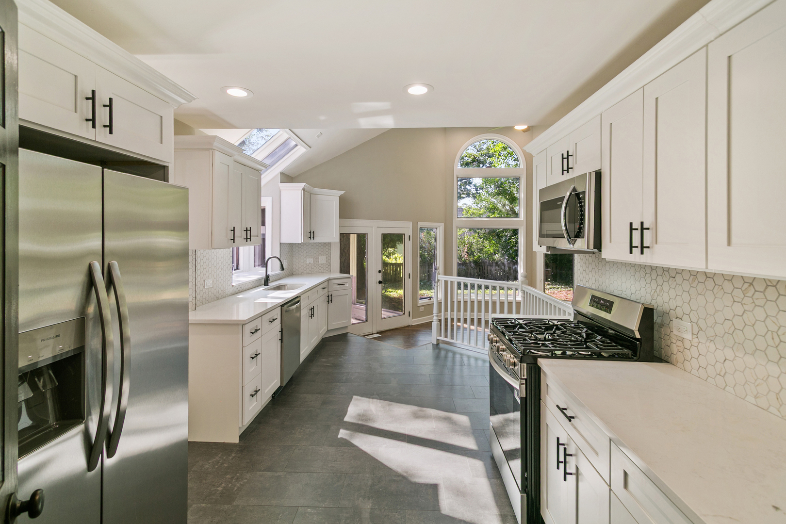 531 Winchester Road Chicago Heights, IL 60411 - Photo 6 of 28 a kitchen with stainless steel appliances granite countertop a refrigerator a stove and a sink with wooden floor
