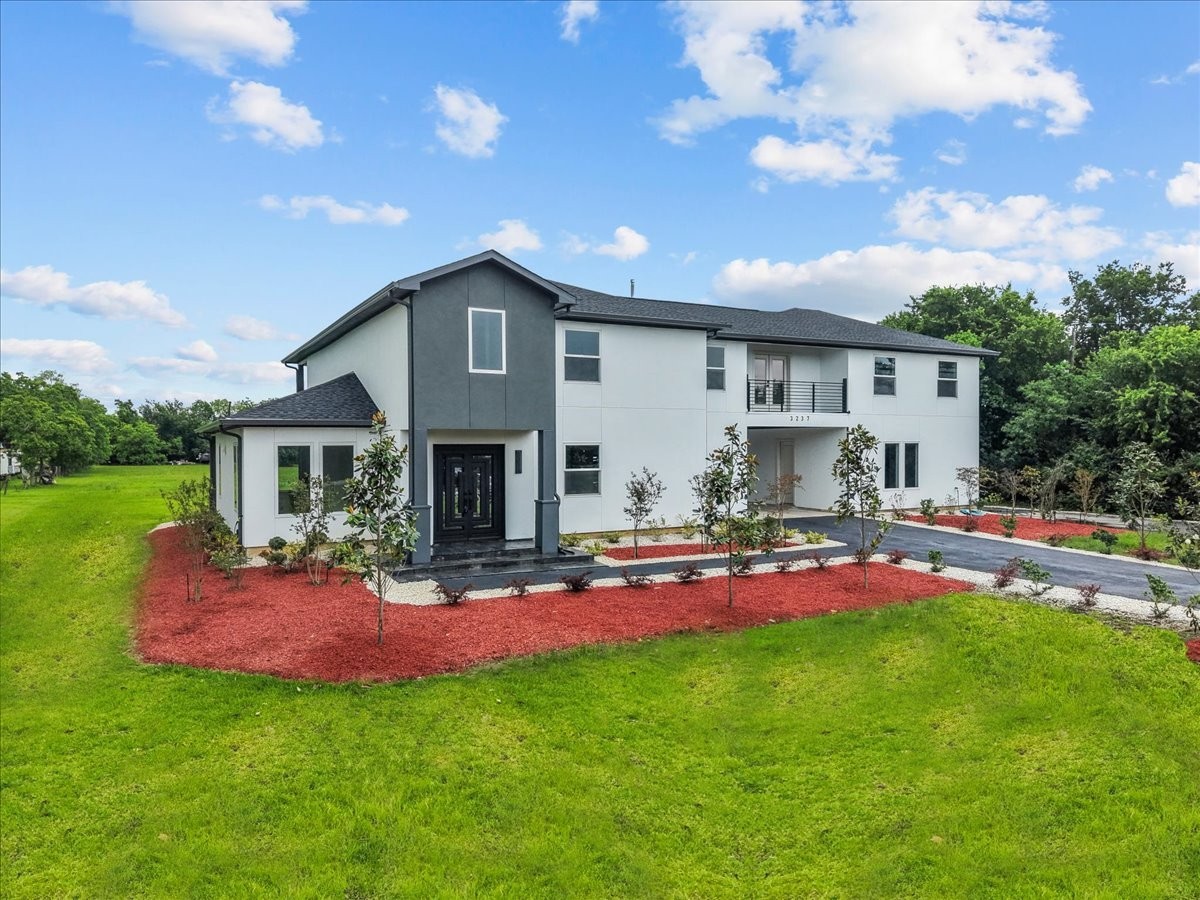 3237 Harkey Road Pearland, TX 77584 - Photo 9 of 46 Sleek modern exterior with fresh landscaping and clean architectural lines.