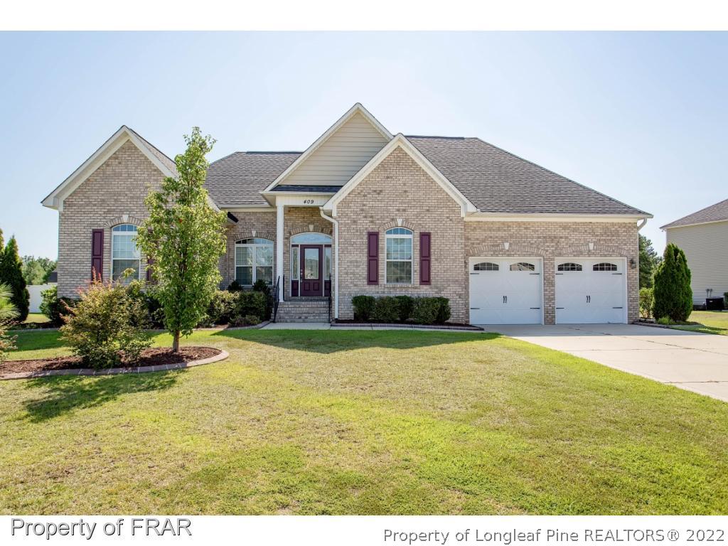 409 St Johns Loop Raeford, NC 28376 - Photo 1 of 36 a view of a house with a yard and garage
