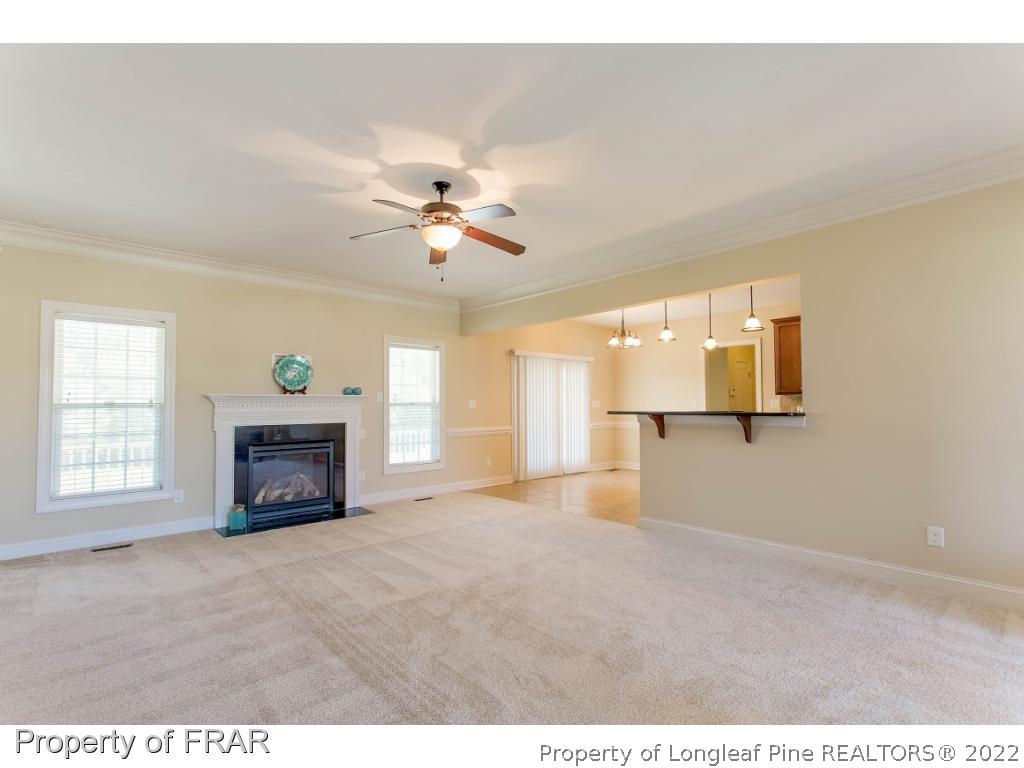 409 St Johns Loop Raeford, NC 28376 - Photo 12 of 36 a view of an empty room with a fireplace and a window