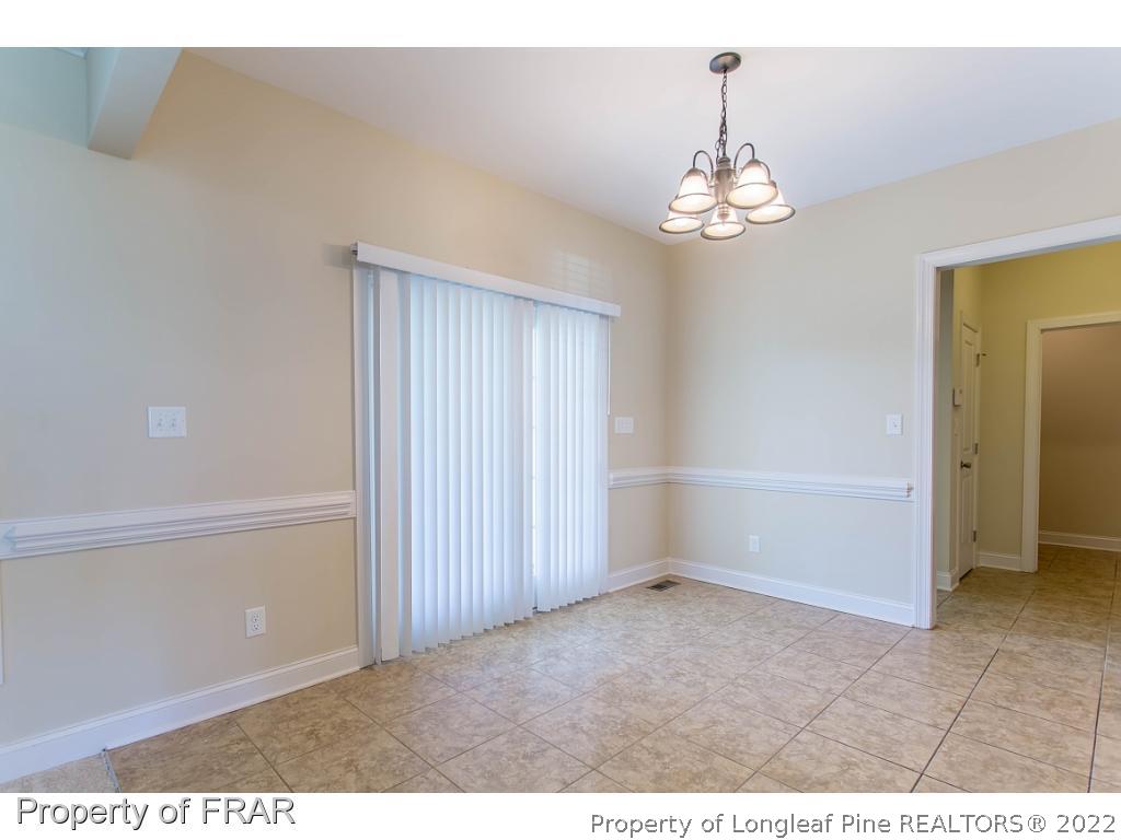 409 St Johns Loop Raeford, NC 28376 - Photo 16 of 36 a view of an empty room with chandelier