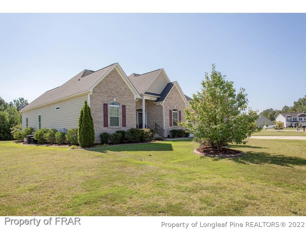 409 St Johns Loop Raeford, NC 28376 - Photo 2 of 36 a front view of a house with a yard