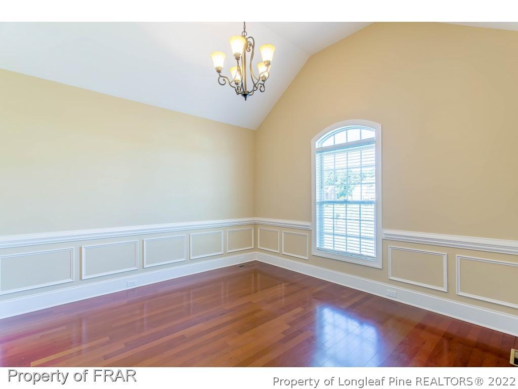 409 St Johns Loop Raeford, NC 28376 - Photo 7 of 36 a view of an empty room with wooden floor and a window
