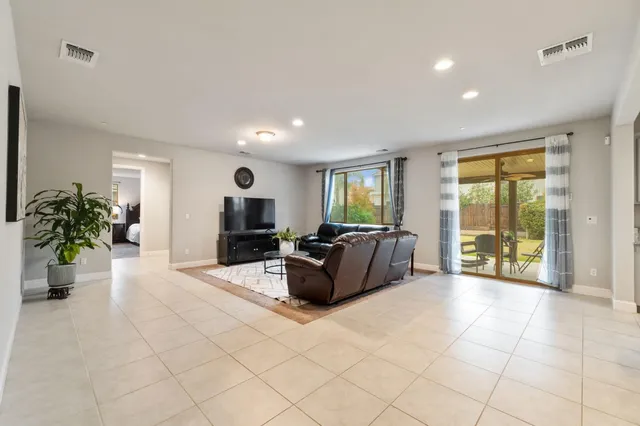 a spacious bedroom with a bed and a large mirror