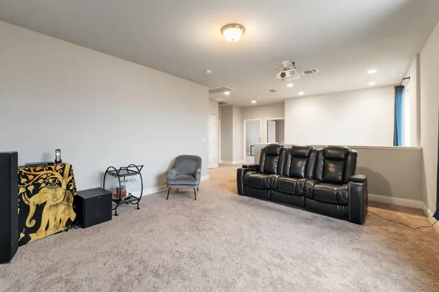 a view of a patio with couches and table and chairs next to yard