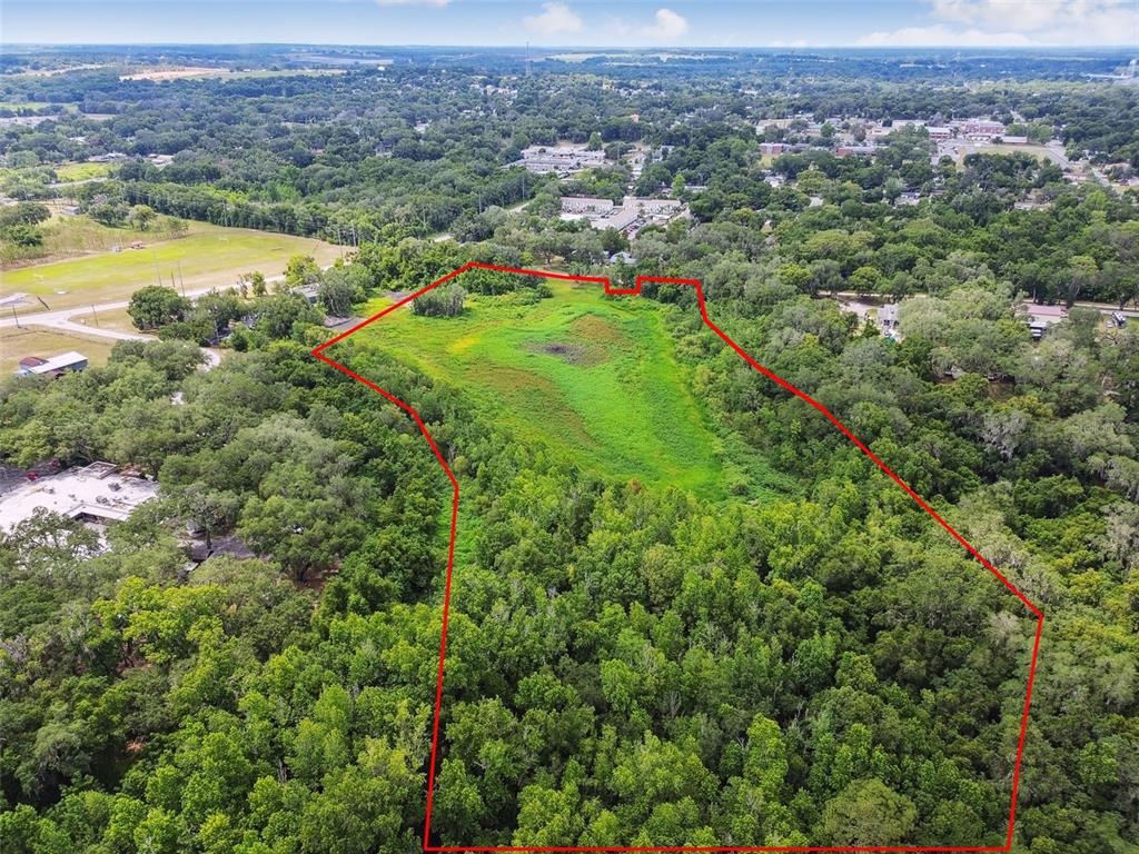 Dixie Avenue Dade City, FL 33525 - Photo 3 of 8 an aerial view of residential houses with outdoor space and swimming pool