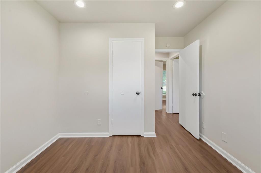 304 East Stone Road Wylie, TX 75098 - Photo 14 of 19 a view of an empty room with wooden floor