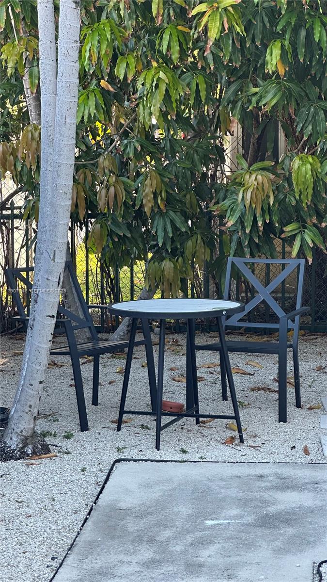421 75th Street, Unit 3 Miami Beach, FL 33141 - Photo 15 of 21 a view of a chairs and table in the backyard
