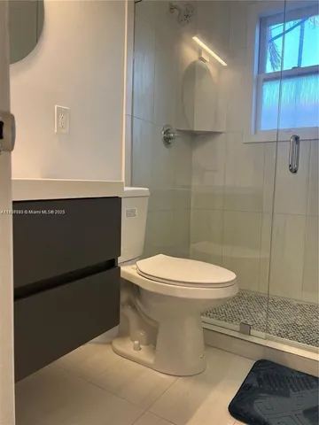 a white toilet sitting next to a bathroom sink