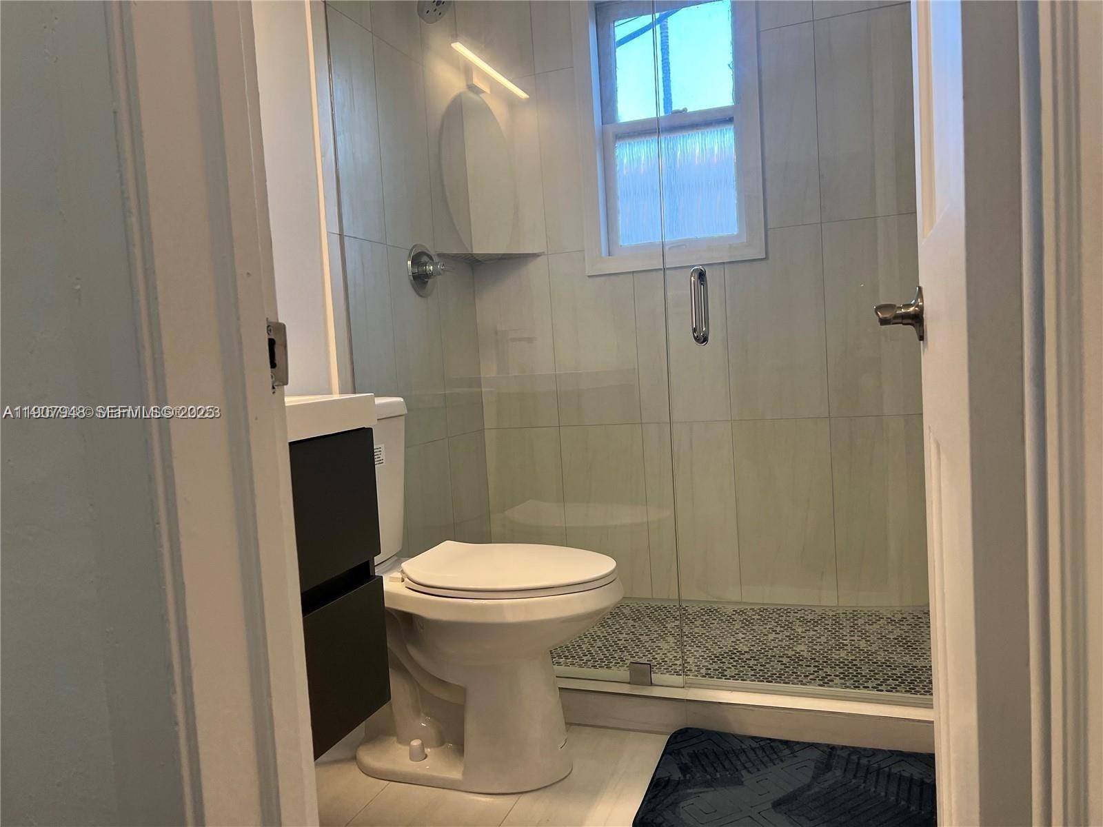 421 75th Street, Unit 3 Miami Beach, FL 33141 - Photo 8 of 21 a bathroom with a sink and a toilet