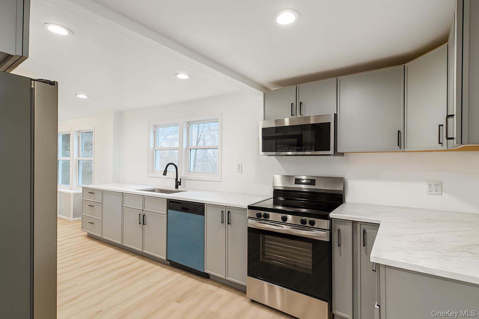 88 Cold Spring Road Liberty, NY 12754 - Photo 4 of 32 Kitchen with gray cabinets, appliances with stainless steel finishes, light wood-style flooring, recessed lighting, and light stone counters