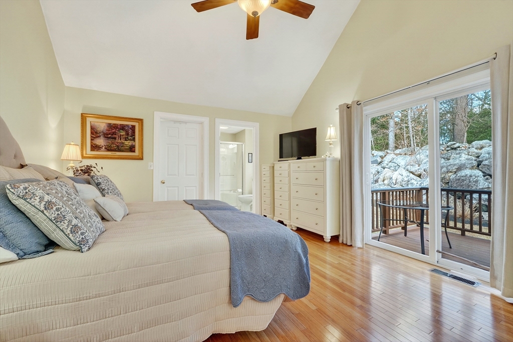 102 Central Street, Unit 5A Saugus, MA 01906 - Photo 11 of 31 a bedroom with a large bed and a chandelier