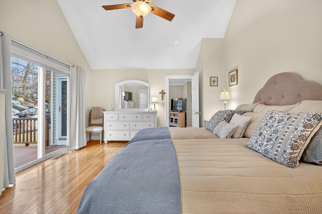 102 Central Street, Unit 5A Saugus, MA 01906 - Photo 12 of 31 a bedroom with a large bed and a chandelier