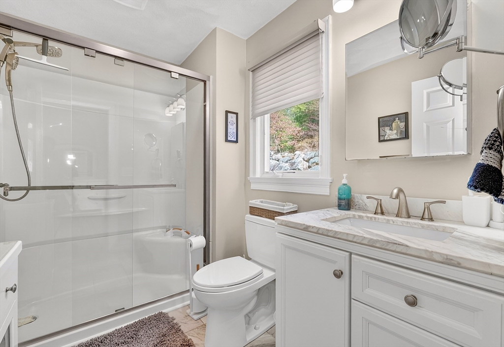 102 Central Street, Unit 5A Saugus, MA 01906 - Photo 13 of 31 a bathroom with a granite countertop sink a toilet and shower