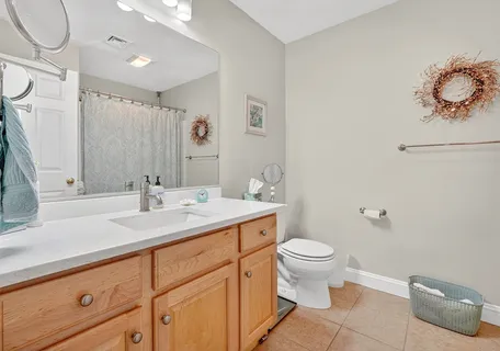 a bathroom with a sink a toilet and mirror